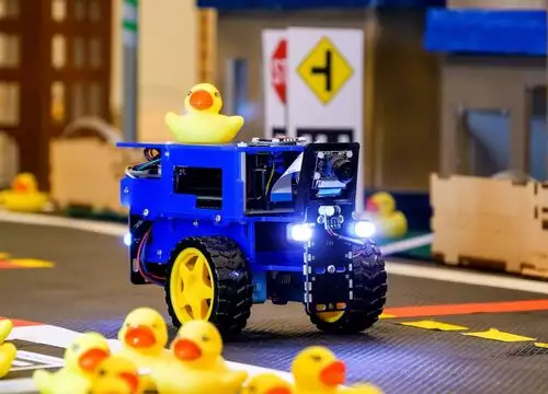 Duckiebot db21 on road with duckies in front